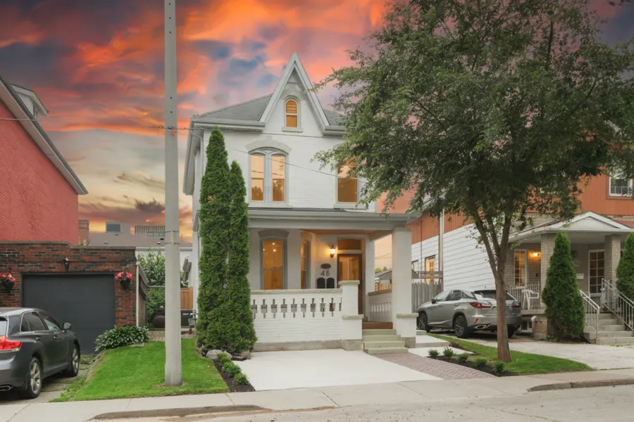The same photograph after a one-click day-to-dusk conversion: sunset sky, windows lit